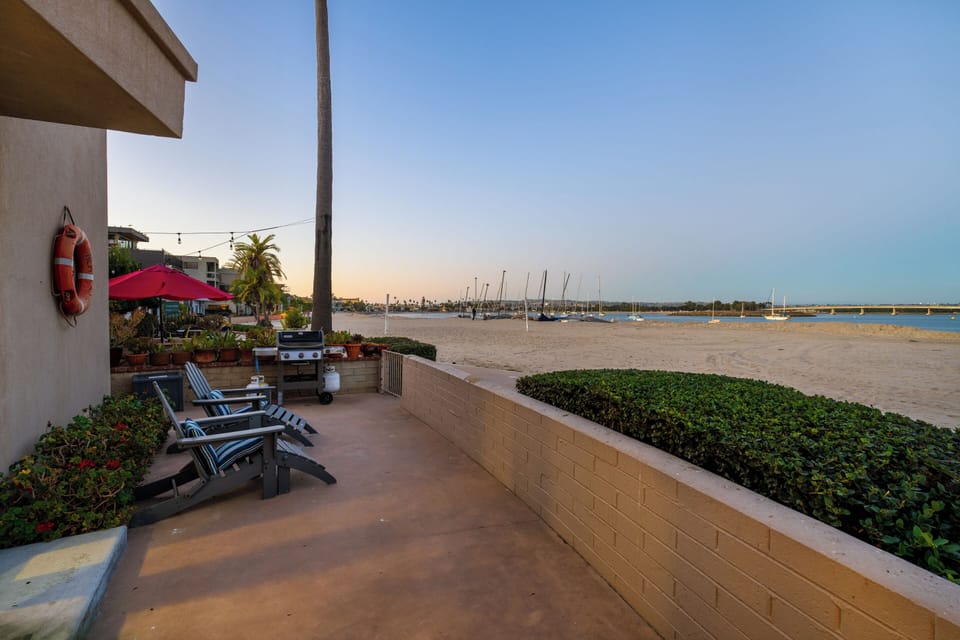 This large outdoor space includes sunbeds, and a grill.