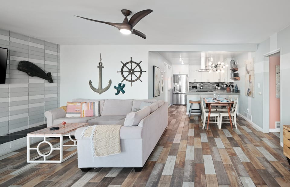 Spacious living area with dining space and open kitchen with bar seating.
