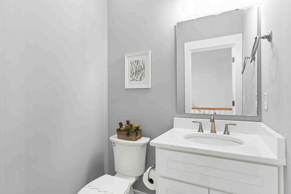 A convenient half bath is located on the top level near the main living and dining areas.