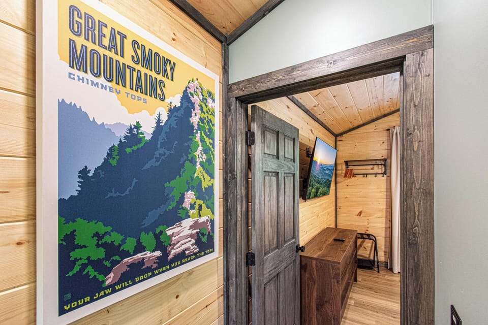 Your bedroom entrance is graced by a captivating canvas portraying the Great Smoky Mountains. This stunning visual invites you to unwind in a space where nature seamlessly merges with modern comfort, promising a retreat filled with  relaxation.