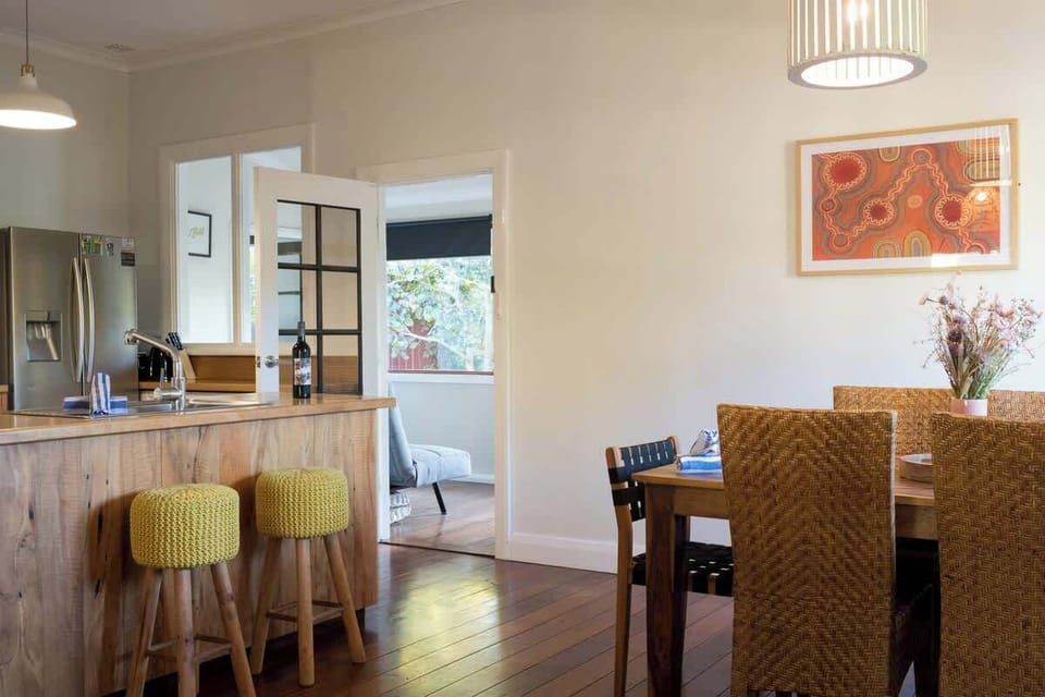 Gather here in the dining area for slow breakfasts or shared meals with wine, laughter, and views of the garden beyond.