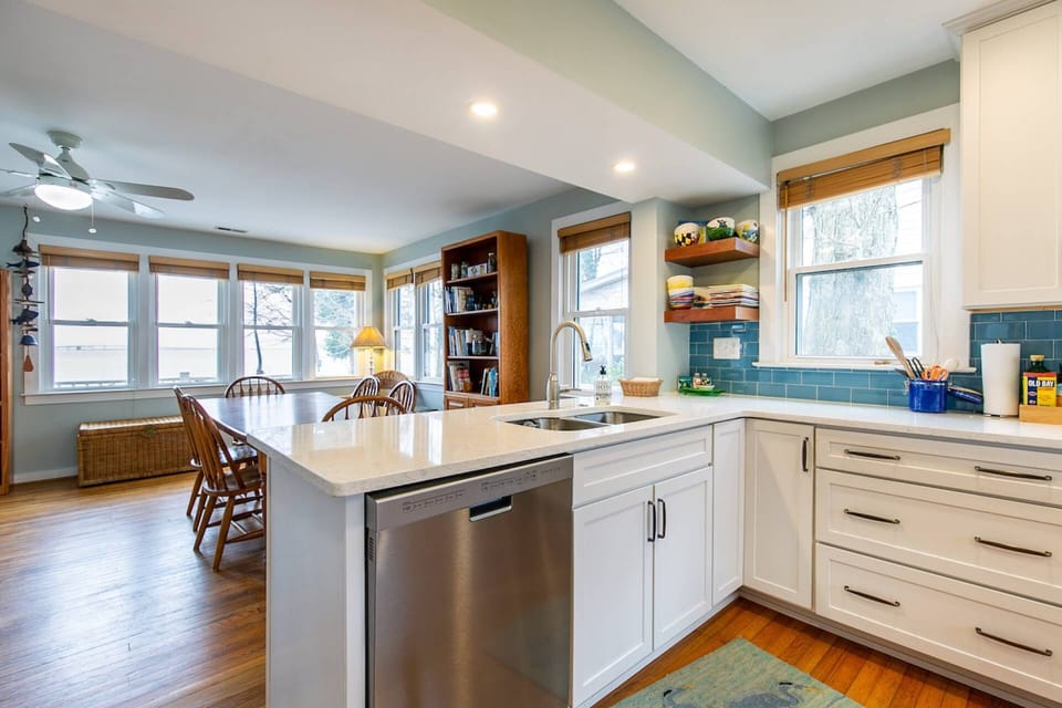 The kitchen overlooks the dining room and the waterfront backyard.