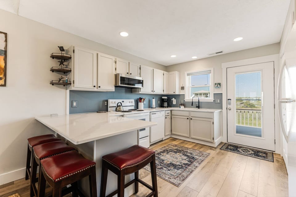 A fully-stocked kitchen with new appliances & seating for 4 at the bar. Entertain the cook or use it as a mobile workstation.