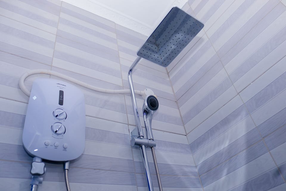Shower, rainfall showerhead, slippers, towels