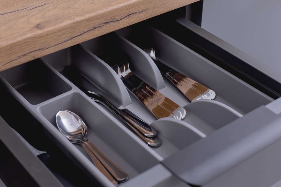 A close-up of a cutlery drawer, showcasing modern and functional kitchen utensils.

