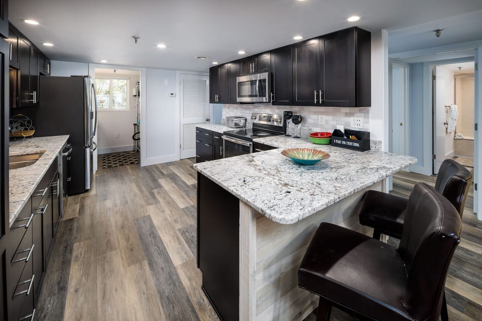 Additional bar seating - Pretty counter tops and cabinets make cooking dreamy