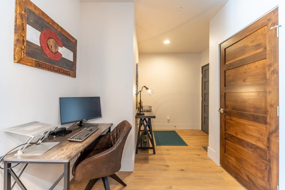 Your dedicated workspace awaits with a sleek desk setup and computer, perfect for staying productive during your stay.