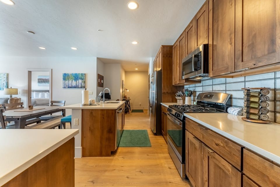 Your spacious kitchen features warm wood cabinets, stainless steel appliances, and plenty of counter space for cooking memorable meals together.
