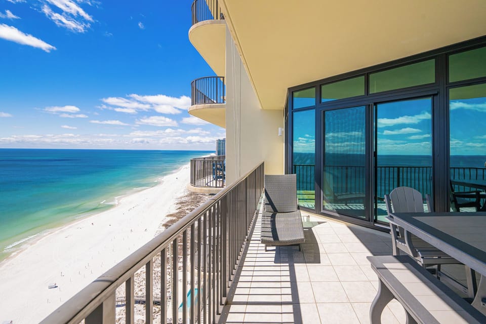 Relax in the lounge chair on your balcony, taking in the stunning views of the beach and coast beyond