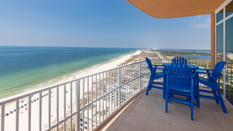 Imagine sipping a cool drink at the blue table while gulf waves and the shoreline stretch below