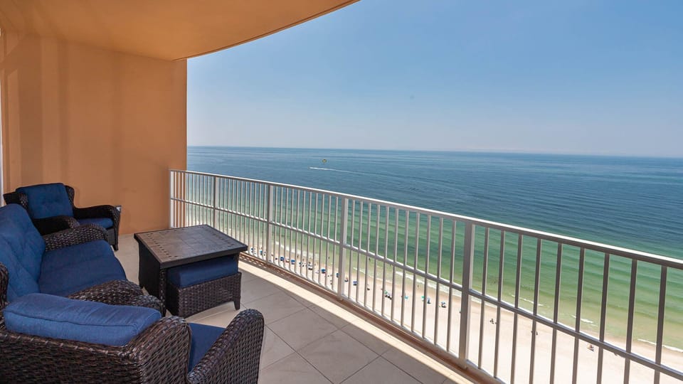 Lounge on cozy seating on the beachfront balcony while listening to gulf waves and watching the shoreline