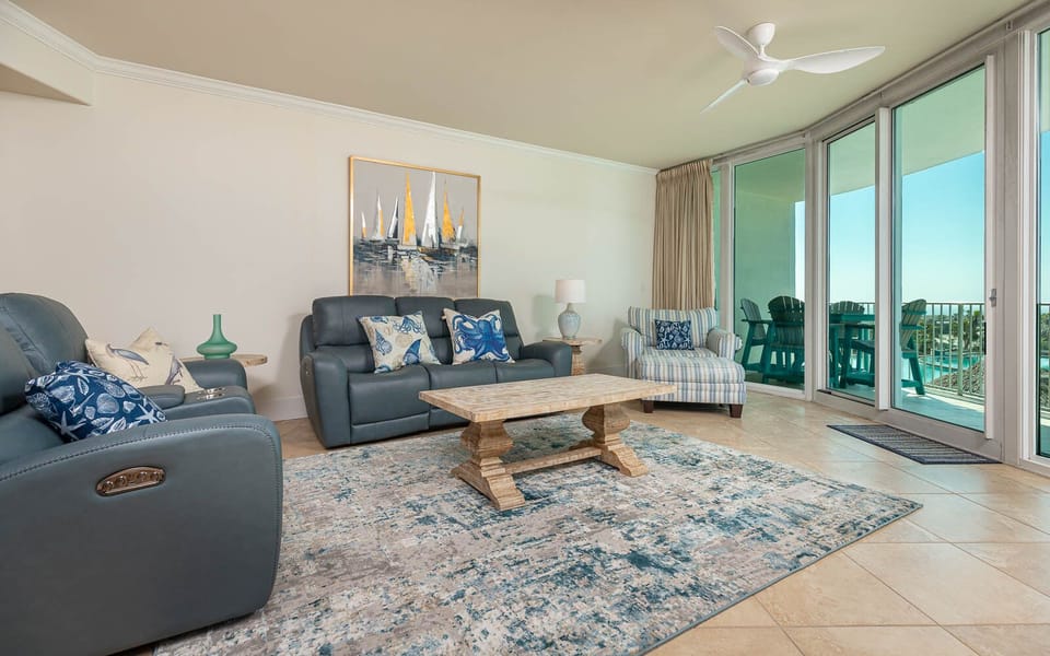 This living area features comfortable seating, a stylish coffee table, and a bright view through expansive glass doors