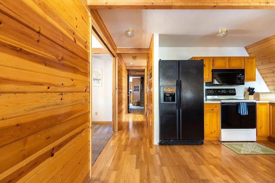 One of two full refrigerators/freezers. Hallway leading towards the other side of the property.