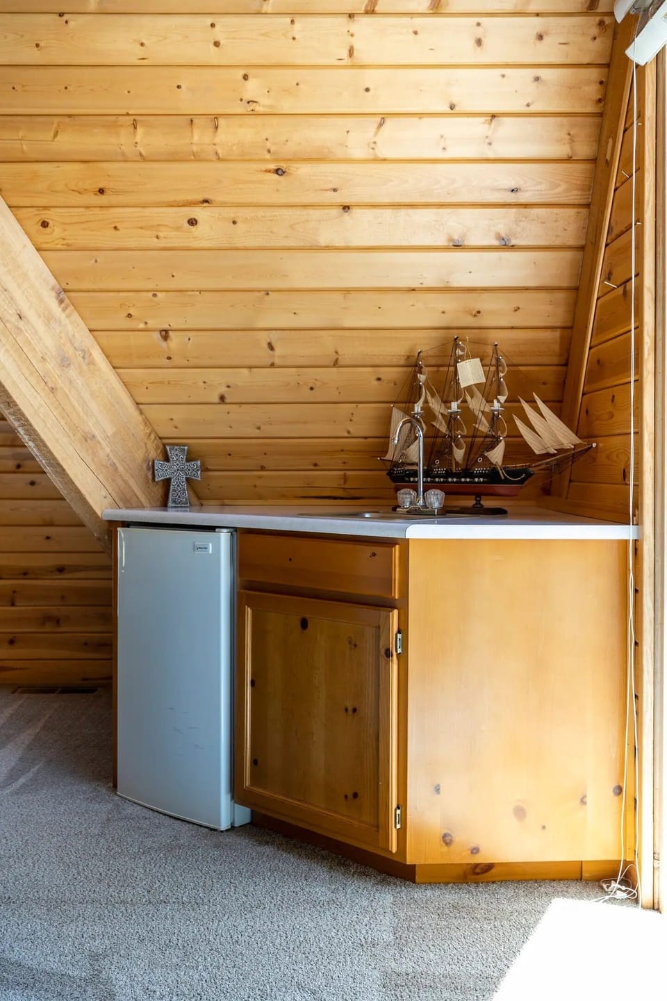 In the other corner is a wet bar with a mini fridge to keep drinks cold and close by.