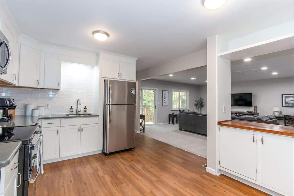 The kitchen flows seamlessly into the spacious living room and back deck, so you can cook while staying part of the fun. Perfect for entertaining and making memories!