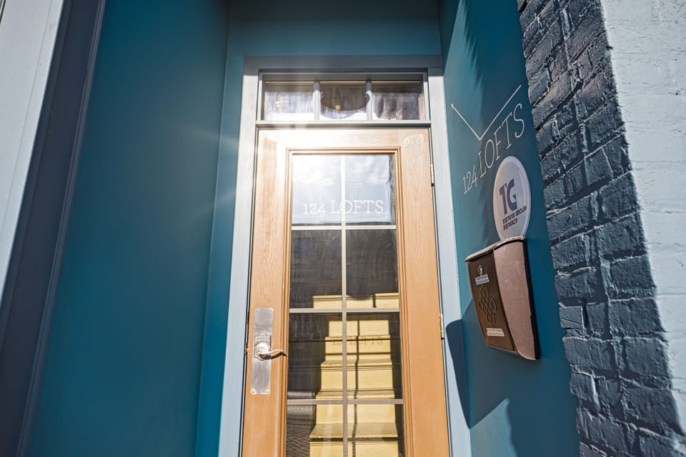Your entry point to 124 Lofts - a distinctive teal door right on Main Street.