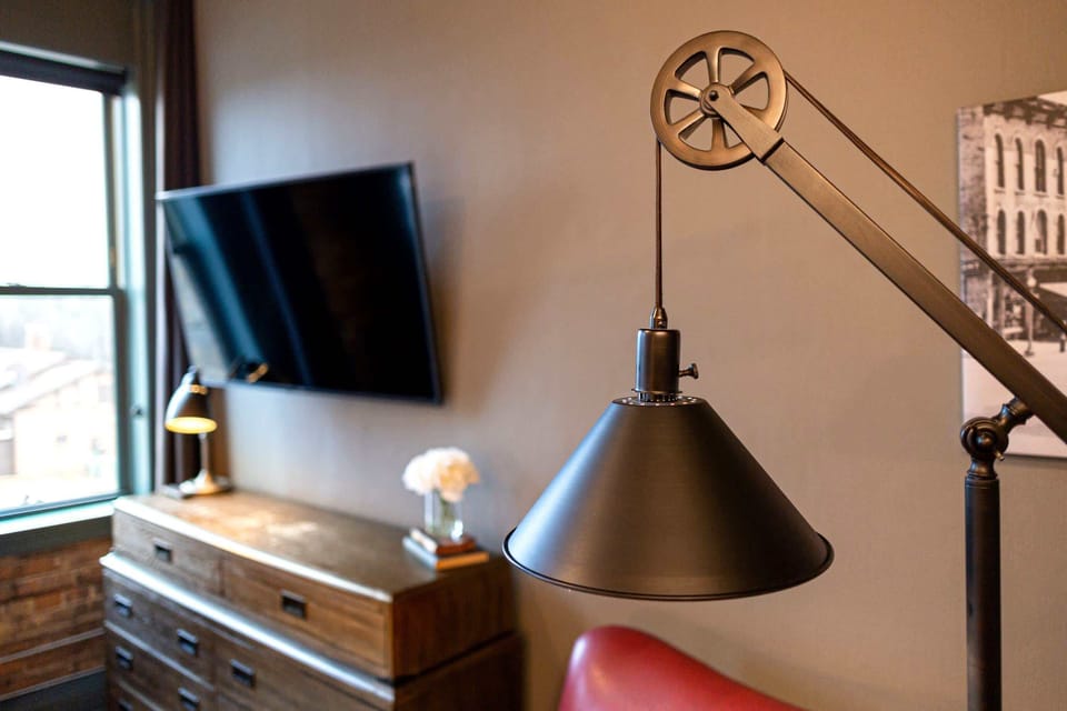 Vintage pulley floor lamp and solid wood dresser - every detail in Loft Four is intentional, industrial, and one of a kind.