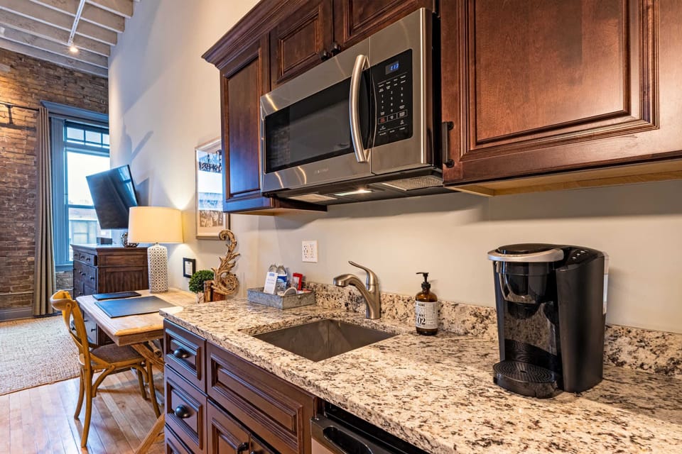 Granite counters, a Keurig, microwave, and mini fridge — everything you need to start the morning without leaving the loft.