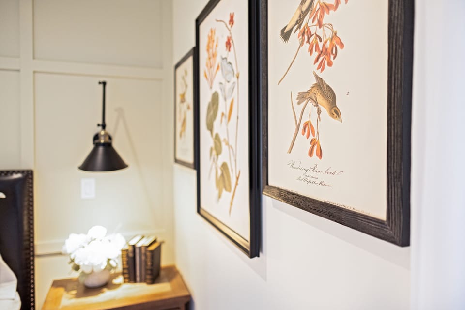 Warm light, curated art, and a sconce that glows just right.