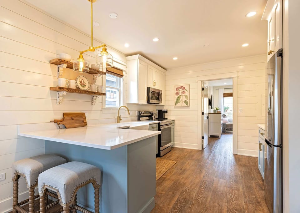 A fully equipped kitchen with modern appliances and farmhouse charm.
