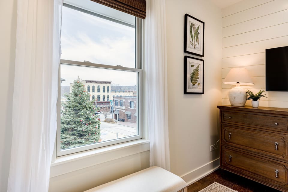 A king bed with a front-row view of historic downtown West Dundee.