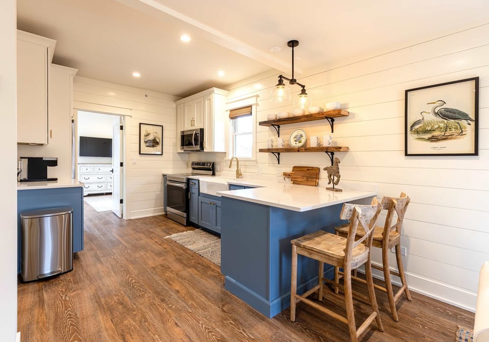 A blue kitchen island with bar stools - pull up a seat and settle in.