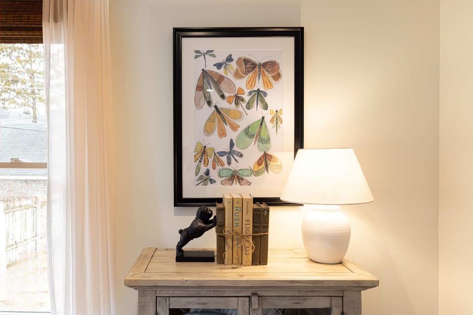 A console table, curated books, and butterfly art - every corner tells a story.