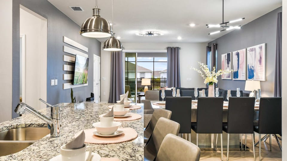 Stylish granite kitchen island and elegant dining area for memorable family meals!
