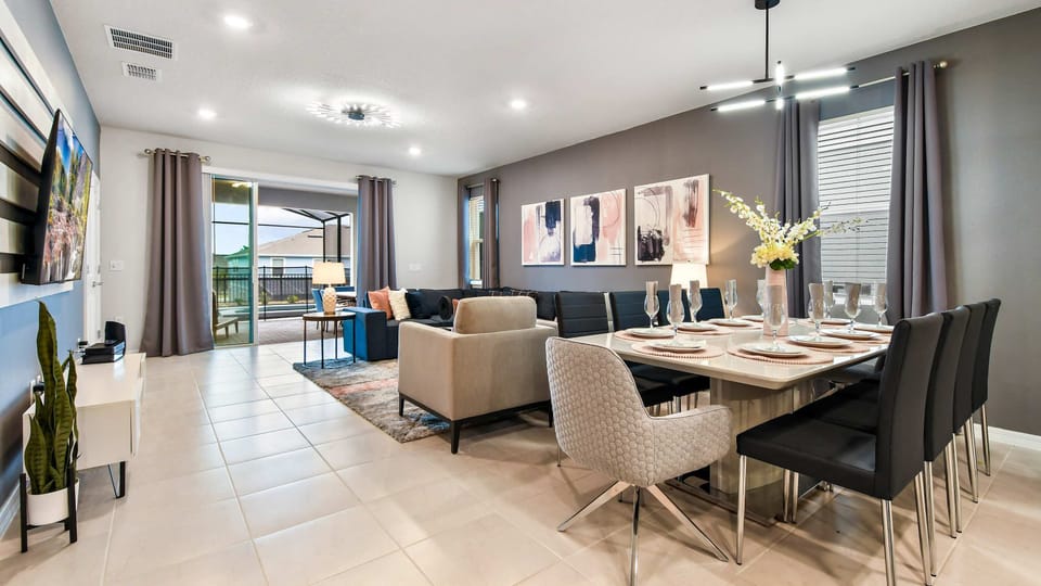 Modern open-concept living and dining area with stylish decor and patio access!
