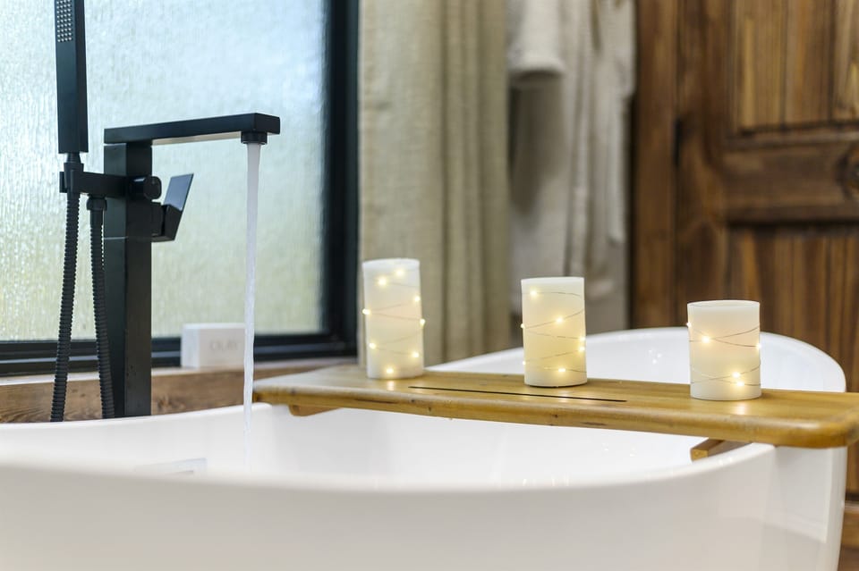 Luxurious Bathroom Oasis: Indulge in serenity with a soaking tub and enchanting candlelit ambiance!