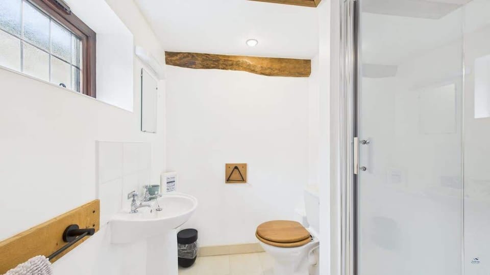 En-suite shower room attached to the master bedroom with modern shower, WC and wash basin.
