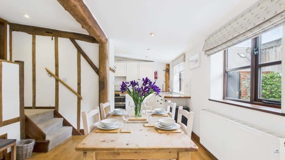 Well-equipped kitchen and dining table at The Cote, ideal for social cooking and meals during your countryside holiday.
