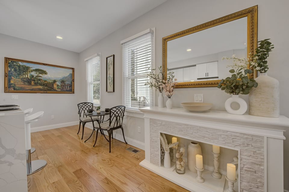 Patio set, fireplace, vintage pictures, and gold mirror combine for a café feel.