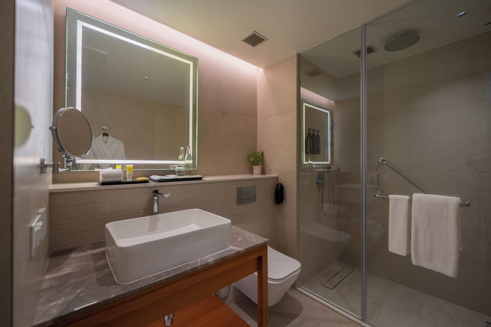 Premier Suite | Bathroom | Designer toiletries, hair dryer, slippers, towels