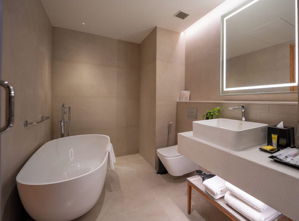 Premier Suite | Bathroom | Designer toiletries, hair dryer, slippers, towels