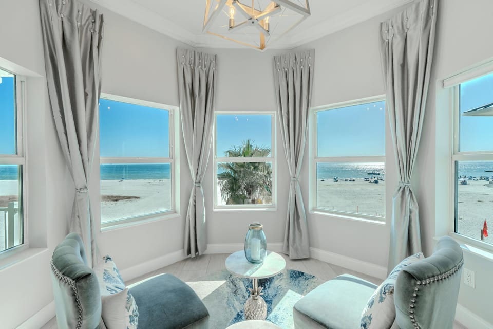 Panoramic beach views, and a relaxing seating area by the windows.
