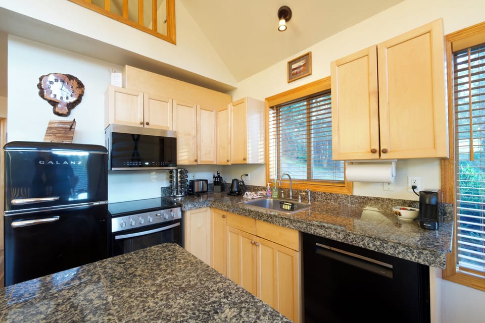 Open kitchen stocked with what you need to cook your meals in our cabin.