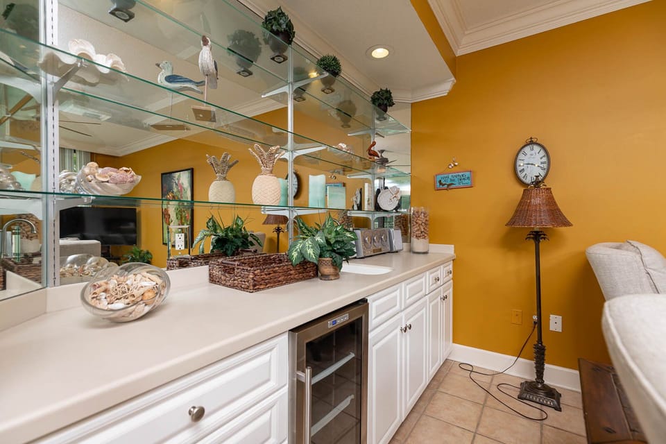 Create refreshing cocktails at the chic wet bar, surrounded by lively decor and beach-inspired accents