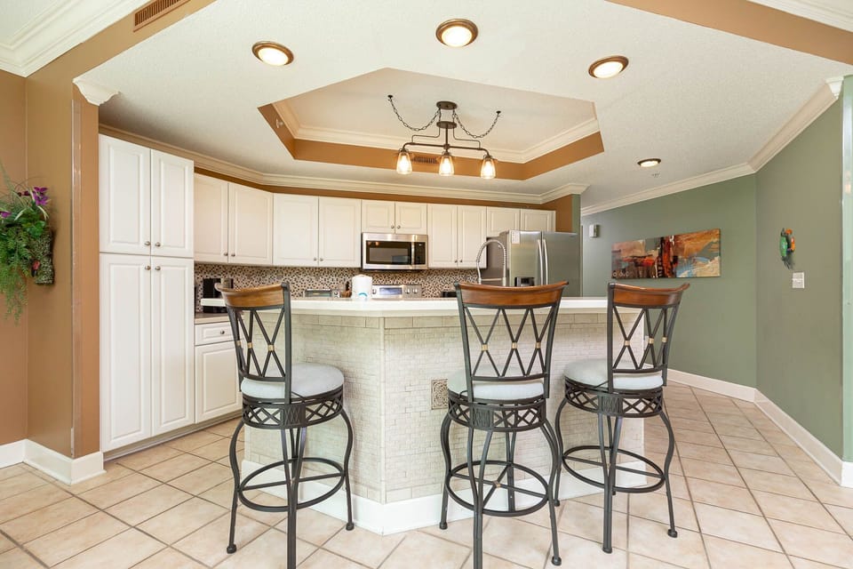Gather with friends at the sleek breakfast bar, enjoying laughter and conversation in this inviting kitchen space