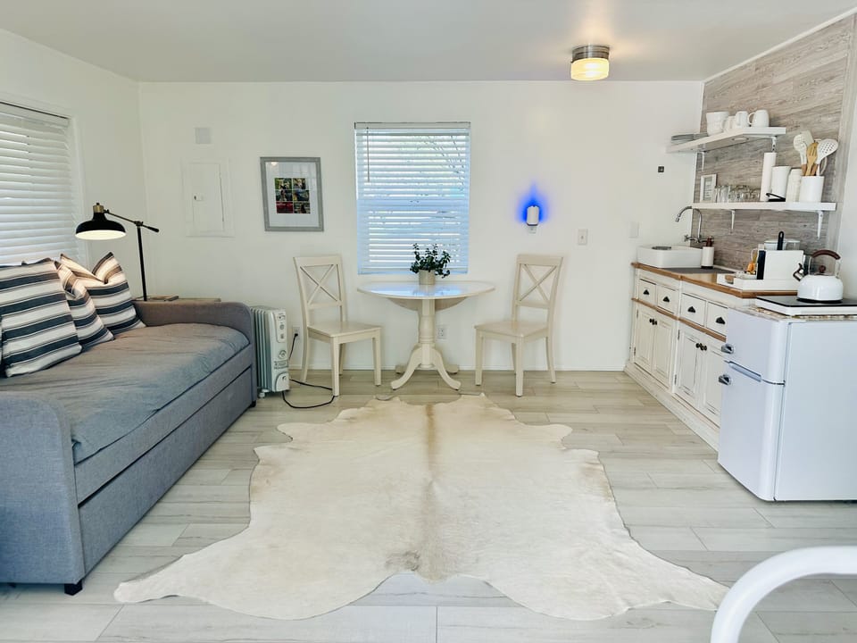 The cottage is one large room with a queen bed at one end and a trundle sofa 
