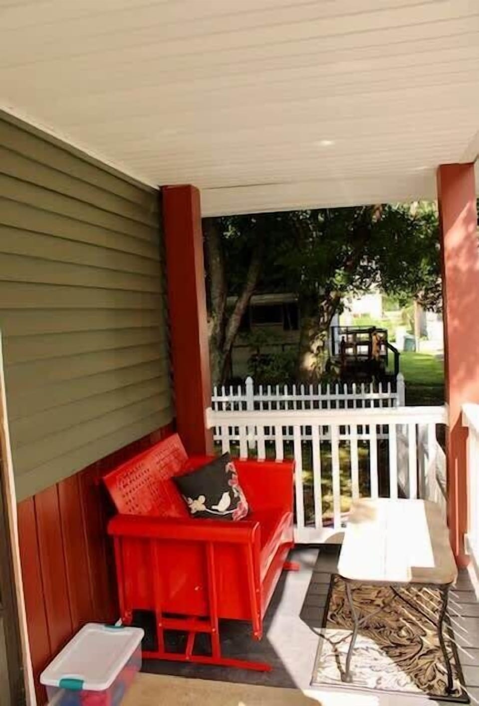 The soothing motion of the glider (with coffee table) on the side porch offers relaxation.