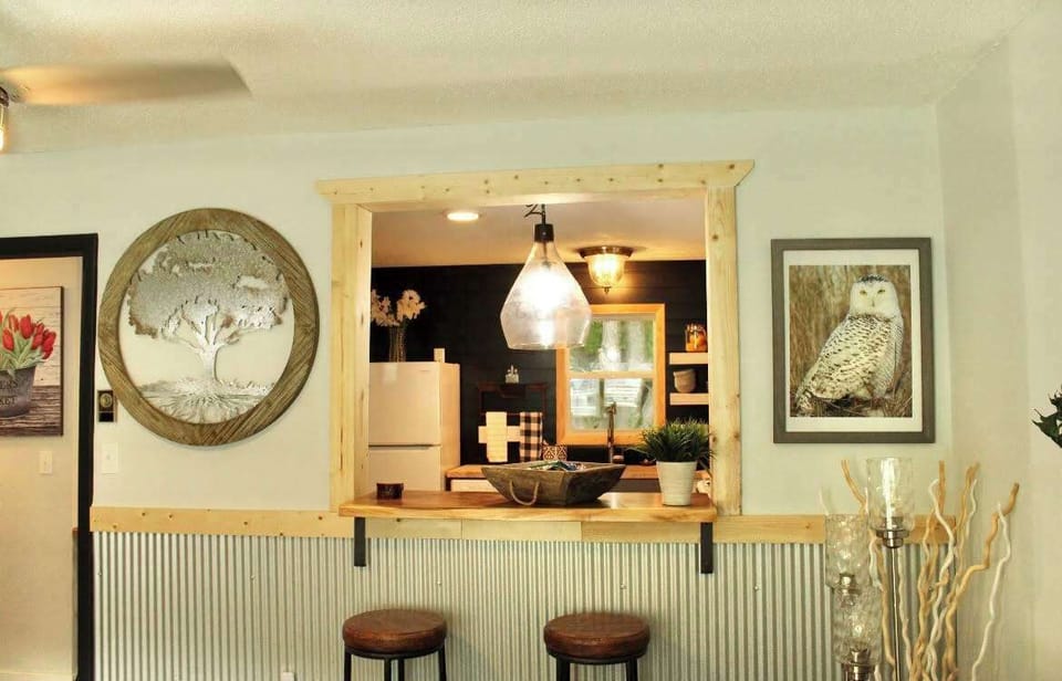 The kitchen’s pass-through window into the living room adds to the openness and enables cooks to be part of the action going on in the living room.