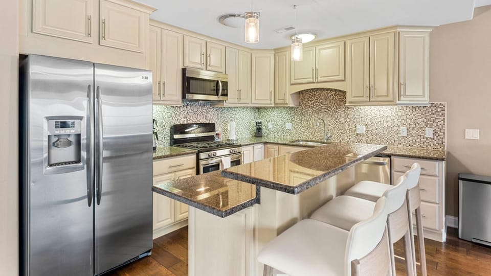 Modern kitchen with granite island and stainless steel appliances