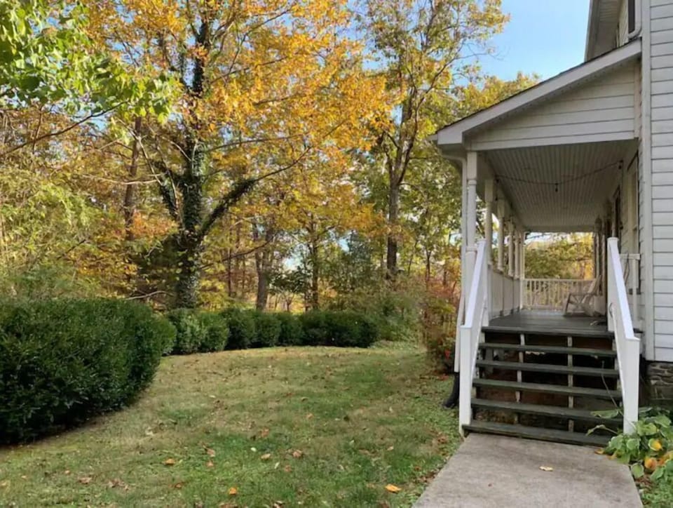 The full-length side porch and yard