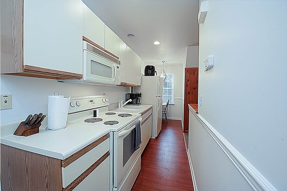 Galley Kitchen with Stove, Oven, Microwave, Sink, and Refrigerator