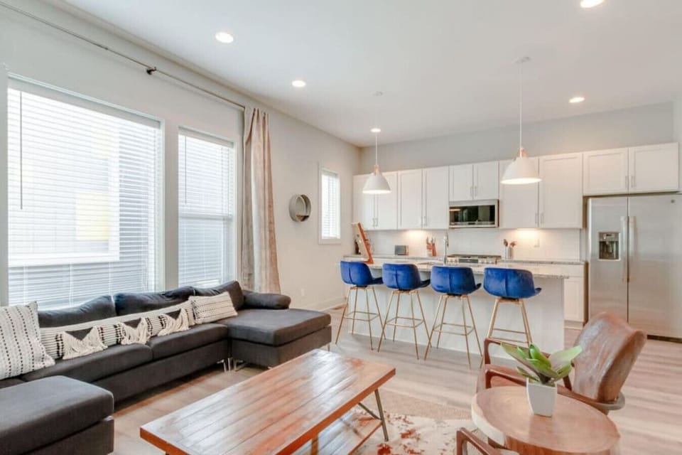 The kitchen is bright and functional with white cabinets and stainless appliances on full display.