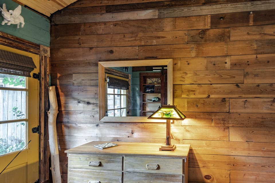 The bedroom features shiplap walls and flying pigs.