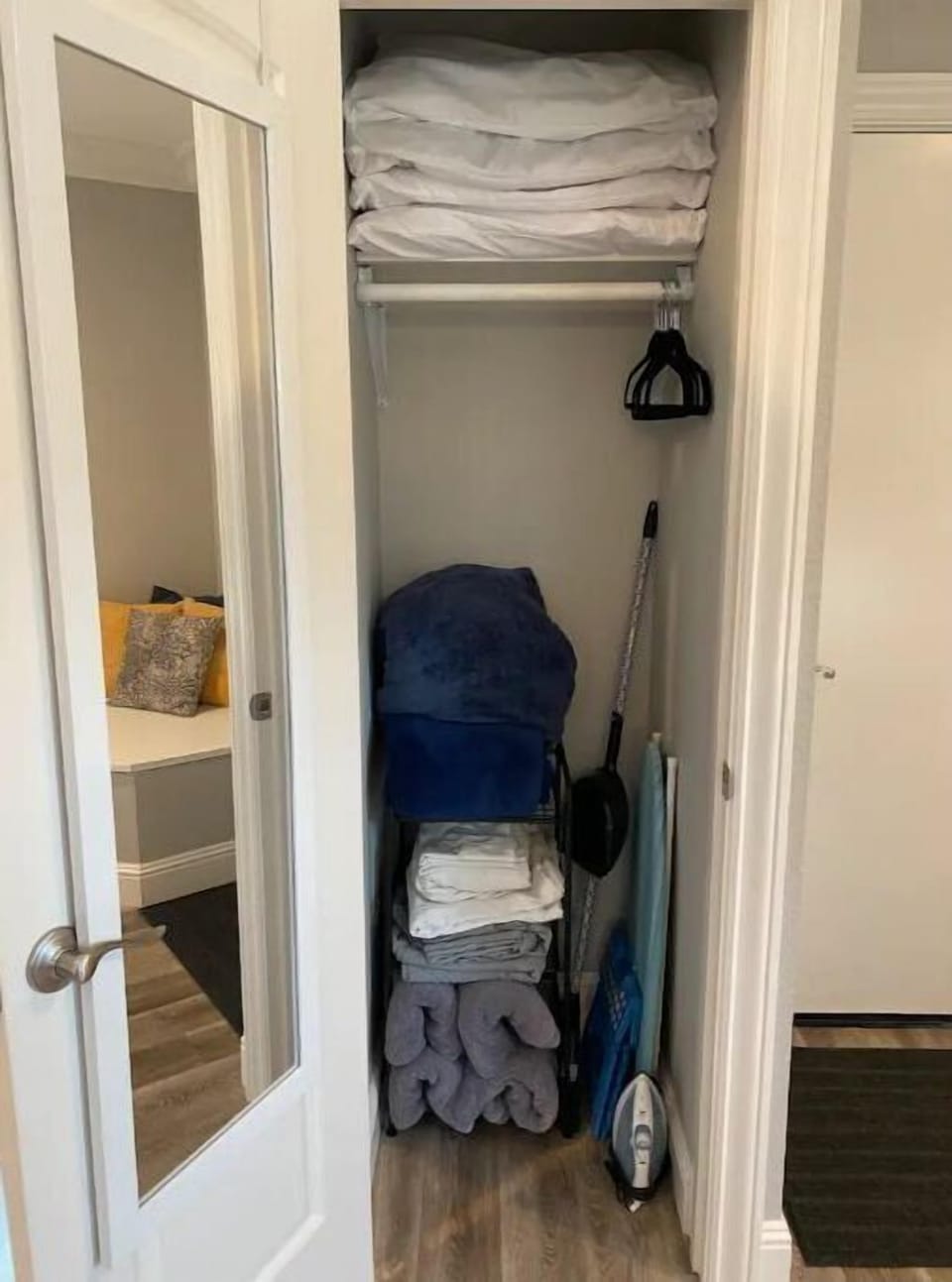 Sofabed linens, blankets, pillows; iron, ironing board, hangars; stepstool