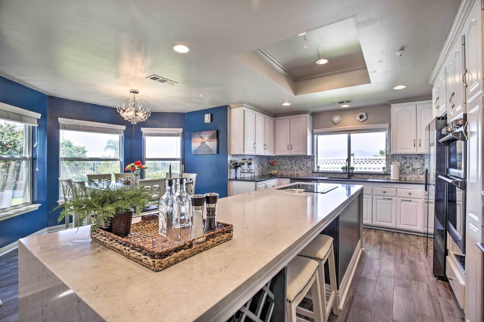 Spacious kitchen with island seating, modern appliances, and bold blue walls!