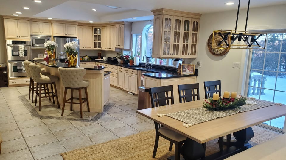 View of Chef's Kitchen and second full sized 8 person dinner table.